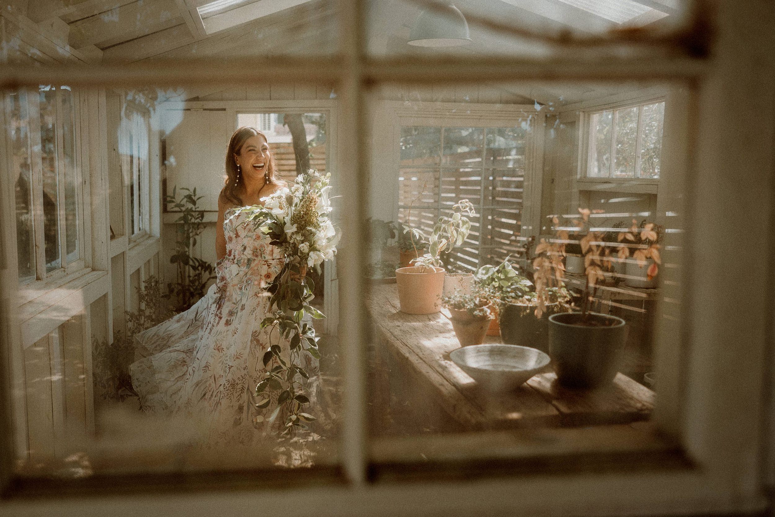 bride in floral dress in greenhouse at bodega in los alamos