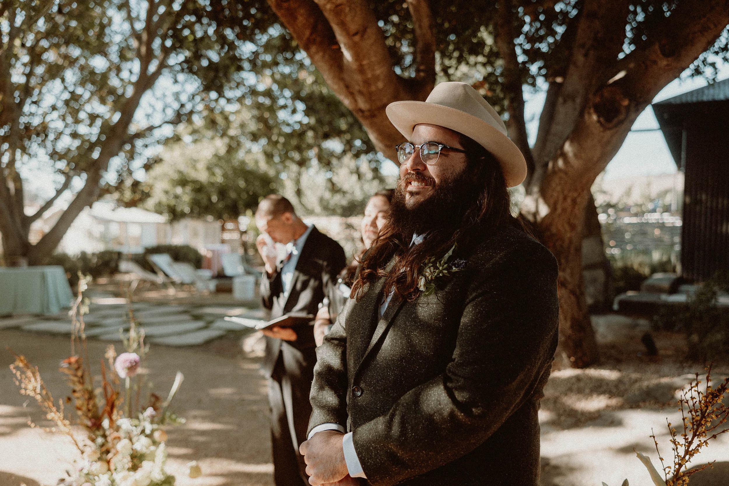 groom receiving bride at end of aisle